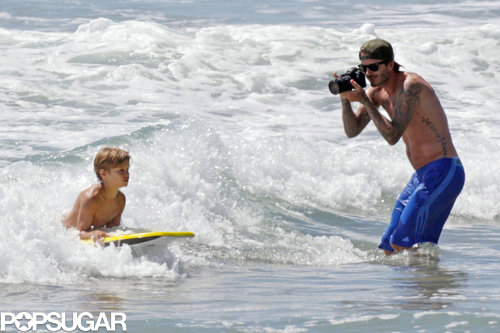 David Beckham photographed his son as he hit the waves in LA.
David Beckham photographed his son as he hit the waves in LA.