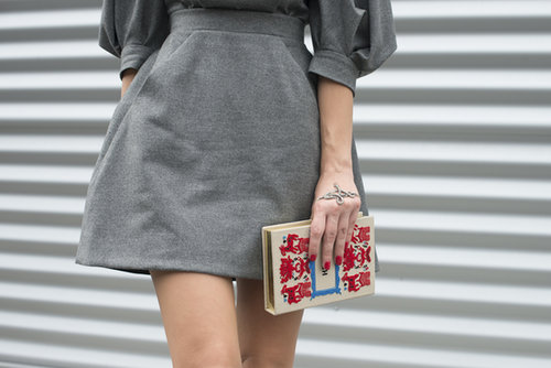 A novel clutch pops against her grays.
A novel clutch pops against her grays.