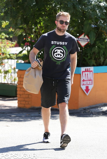 Robert Pattinson wore a Stussy t-shirt. Robert Pattinson wore a Stussy t-shirt.