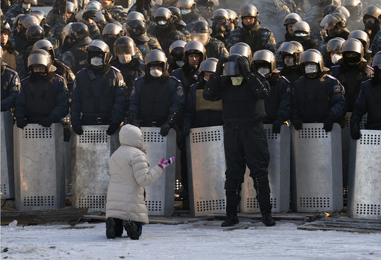 A woman spoke out as she knelt in front of police in Kiev. A woman spoke out as she knelt in front of police in Kiev.