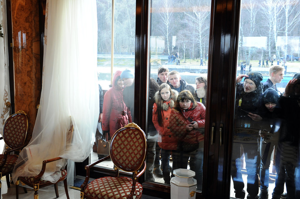 Members of the public looked through the house's windows to see inside. Members of the public looked through the house's windows to see inside.