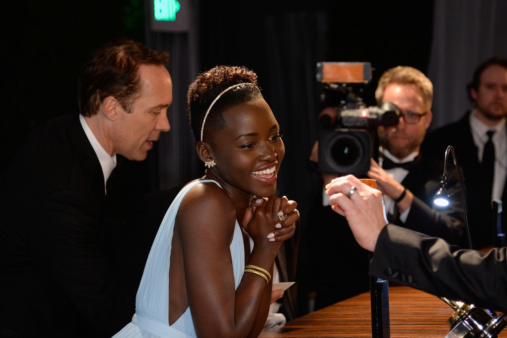 Lupita smiled while checking over her name. Lupita smiled while checking over her name.