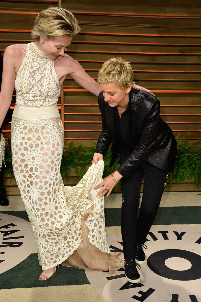 Ellen DeGeneres helped her wife, Portia de Rossi, out with her train while they posed outside the Vanity Fair bash.
Ellen DeGeneres helped her wife, Portia de Rossi, out with her train while they posed outside the Vanity Fair bash.