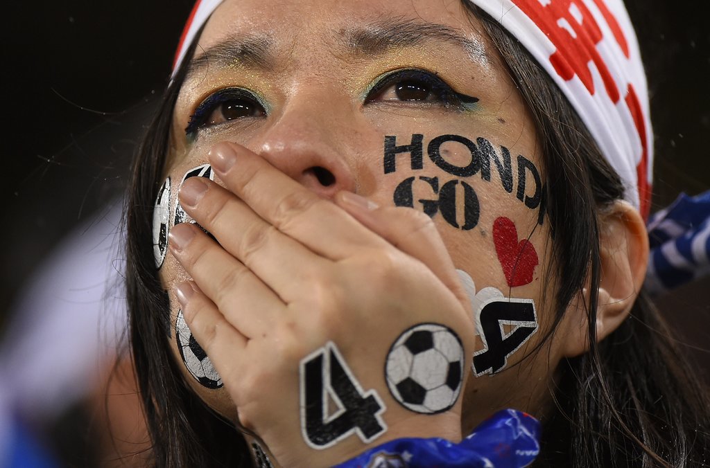 A Japanese fan cried during the game between Japan and Greece.
A Japanese fan cried during the game between Japan and Greece.