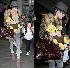 Victoria Beckham at LAX Wearing Fur Jacket and Fedora