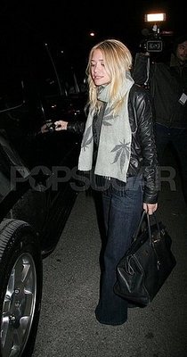 Heading to her car in wide-leg jeans in October