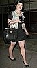 Kelly Osbourne in a Denim Vest Carrying a Top Handle Handbag