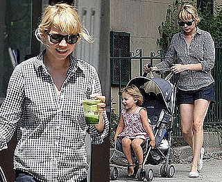 Michelle Williams in a black and white gingham shirt with baby Matilda