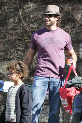 Hugh Flexes His Biceps While Carrying Kiddie Bags