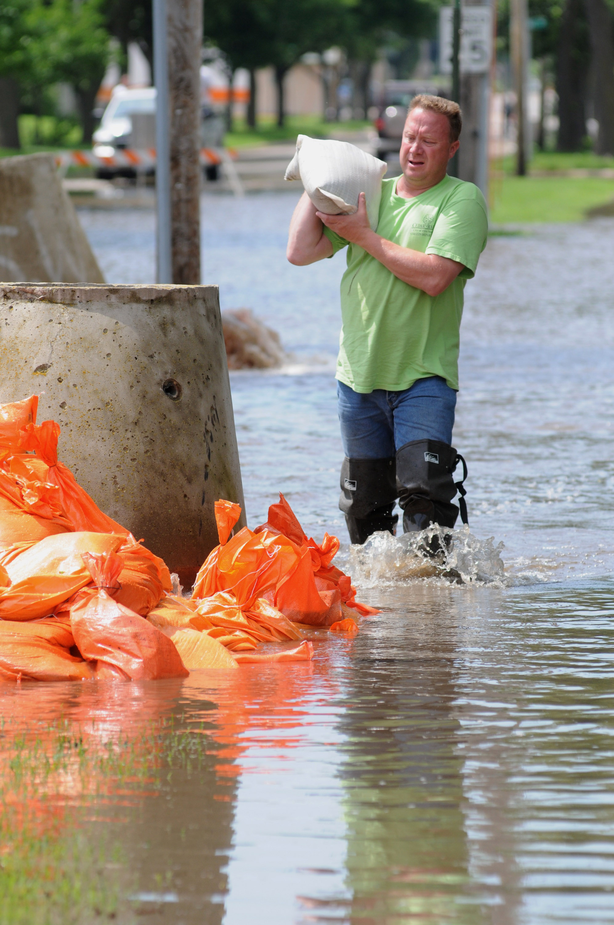 Streets Department employee moves sandbags. Streets Department employee moves sandbags.