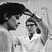 1965: Yves Saint Laurent fits a model at his own fashion house in Paris.