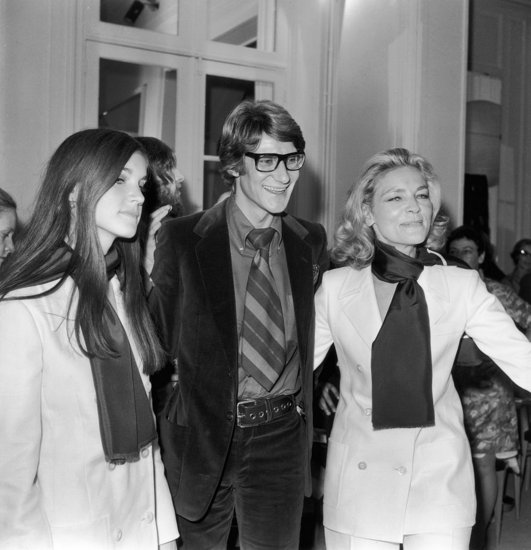 1968: Yves Saint Laurent with Lauren Bacall and her daughter after a showing of his latest collection in Paris.
