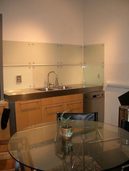 Opposite the Dacor fridge is the sink. We placed a round glass table in the middle to bring the room together. 