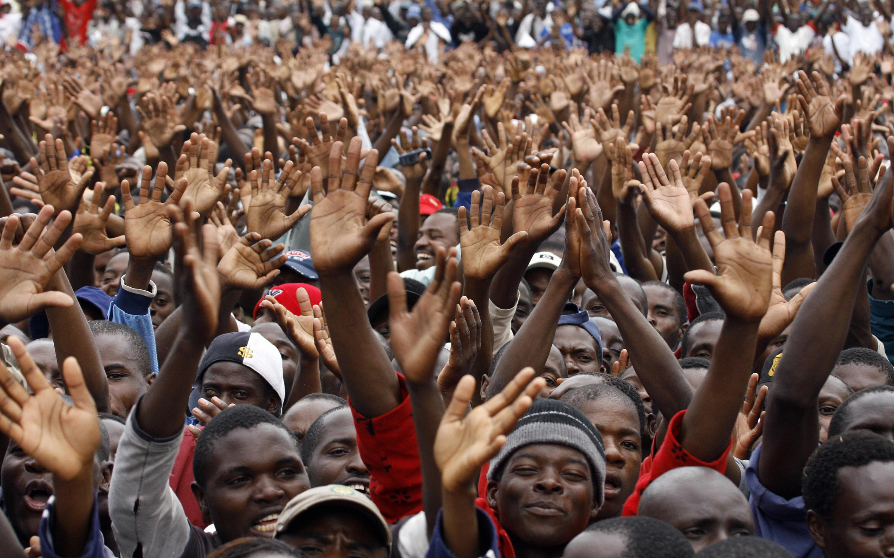 Zimbabaweans greet their new Prime Minister. Zimbabaweans greet their new Prime Minister.