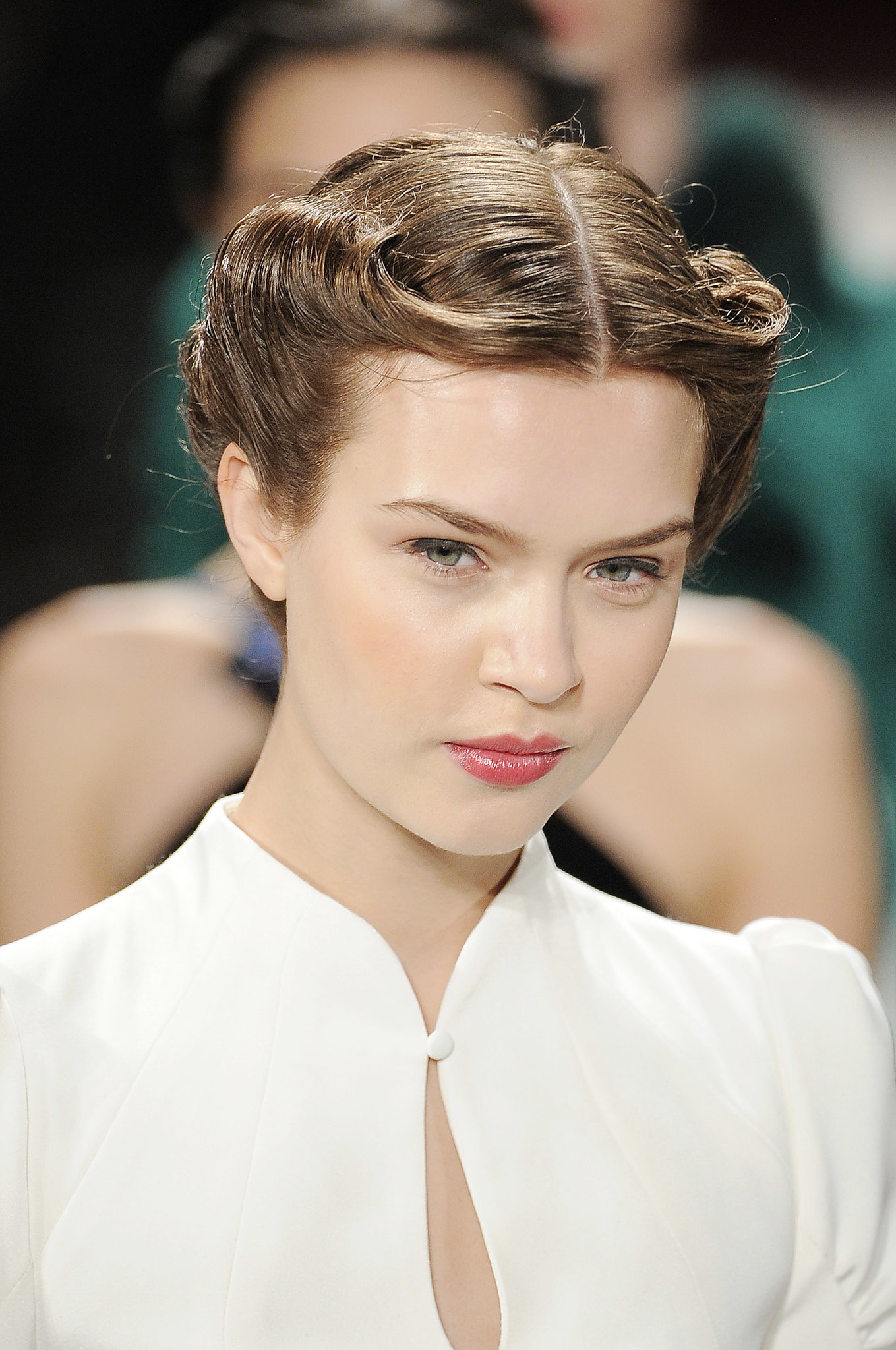 A chic '40s-style rolled updo kept the hair off the face of models in ...